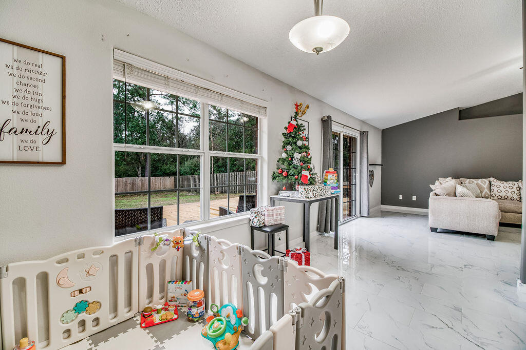 2442 Raider Lane Navarre, FL 32566 - Photo 12 of 46 a bedroom with furniture and a potted plant