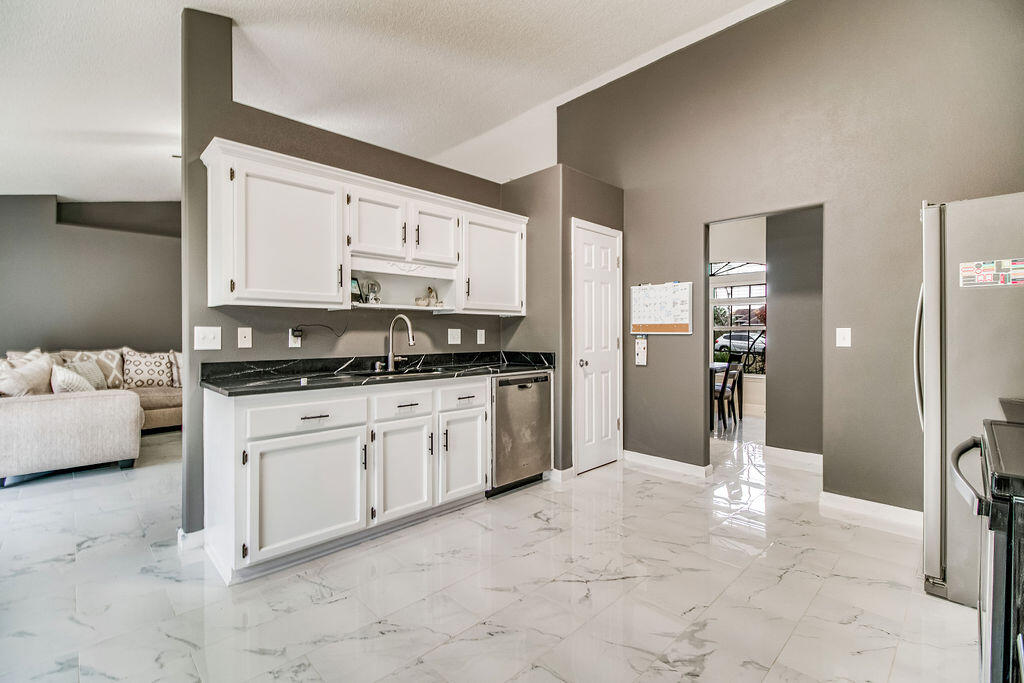 2442 Raider Lane Navarre, FL 32566 - Photo 13 of 46 a kitchen with stainless steel appliances a refrigerator sink and stove