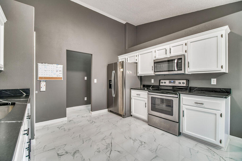 2442 Raider Lane Navarre, FL 32566 - Photo 14 of 46 a kitchen with stainless steel appliances granite countertop a refrigerator stove and sink
