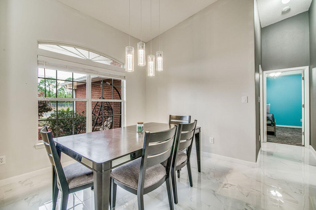 2442 Raider Lane Navarre, FL 32566 - Photo 17 of 46 a view of a dining room with furniture and window