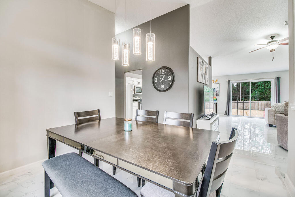 2442 Raider Lane Navarre, FL 32566 - Photo 18 of 46 a dining room with furniture and window