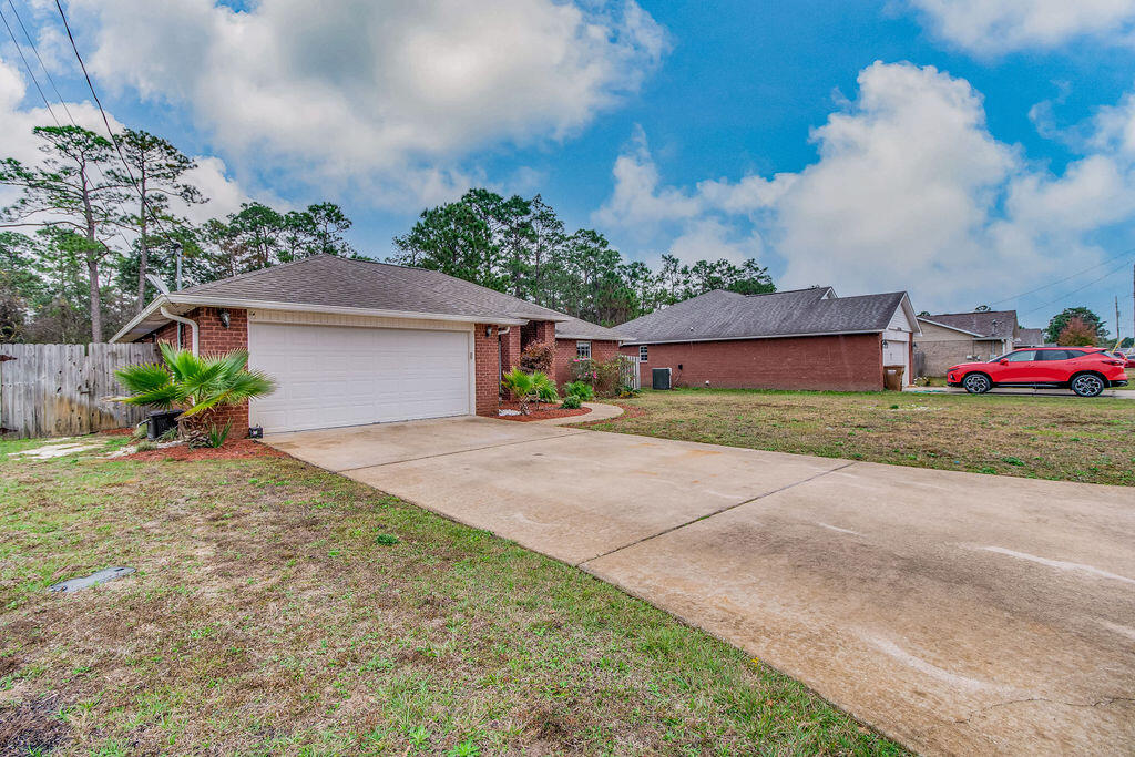 2442 Raider Lane Navarre, FL 32566 - Photo 3 of 46 a front view of house with yard