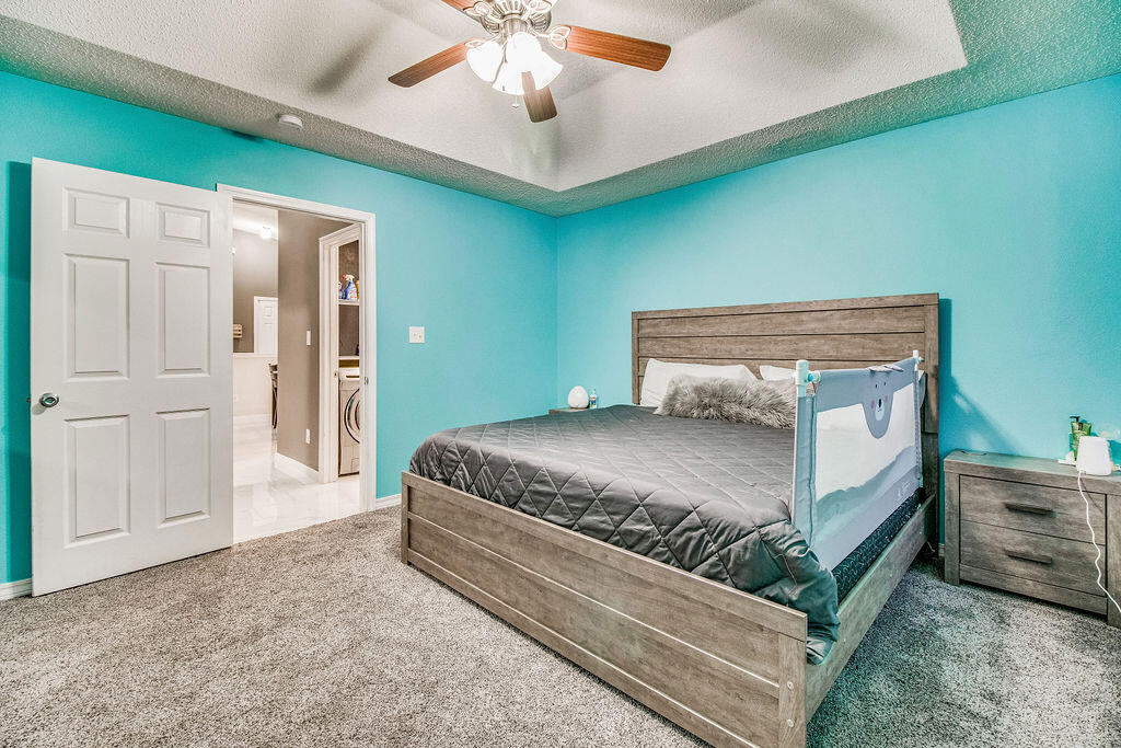 2442 Raider Lane Navarre, FL 32566 - Photo 23 of 46 a bedroom with a bed and a chandelier