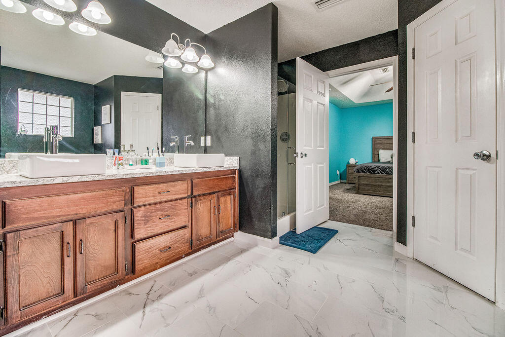 2442 Raider Lane Navarre, FL 32566 - Photo 26 of 46 a spacious bathroom with a sink and a mirror