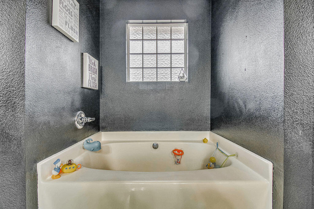 2442 Raider Lane Navarre, FL 32566 - Photo 27 of 46 a bath tub sitting in a bathroom next to a window