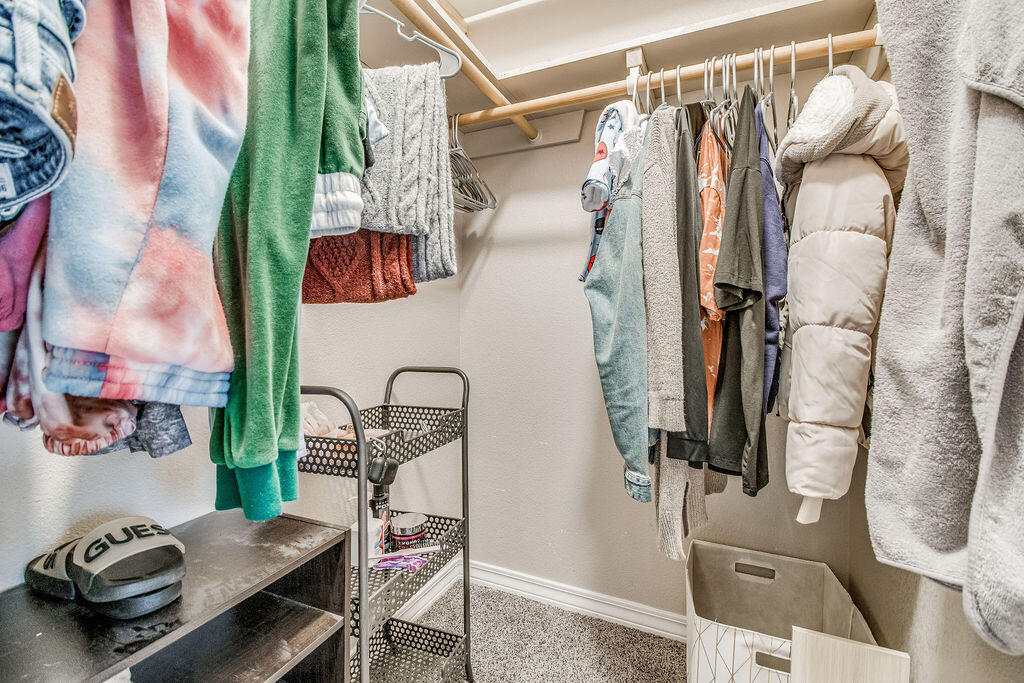 2442 Raider Lane Navarre, FL 32566 - Photo 29 of 46 a view of walk in closet with clothes and shoes