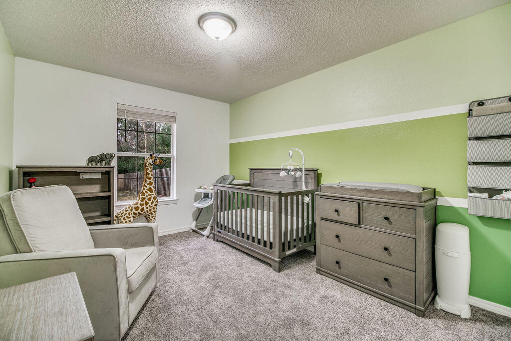 2442 Raider Lane Navarre, FL 32566 - Photo 32 of 46 a bedroom with furniture and a window