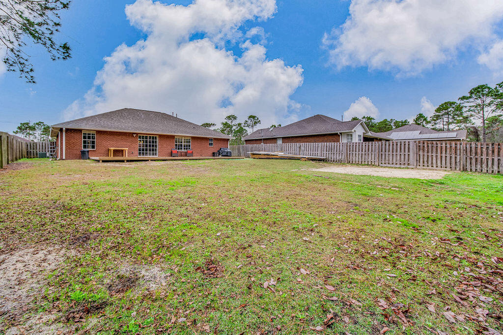 2442 Raider Lane Navarre, FL 32566 - Photo 43 of 46 a view of a big house with a big yard and large trees