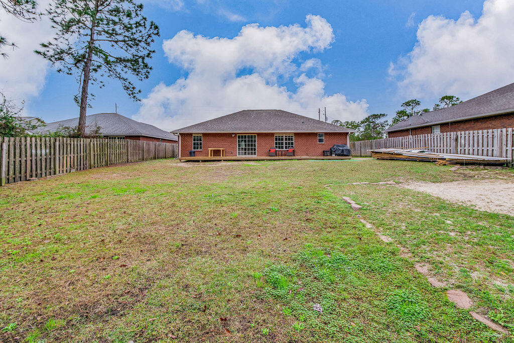 2442 Raider Lane Navarre, FL 32566 - Photo 44 of 46 a view of a big house with a big yard and large trees