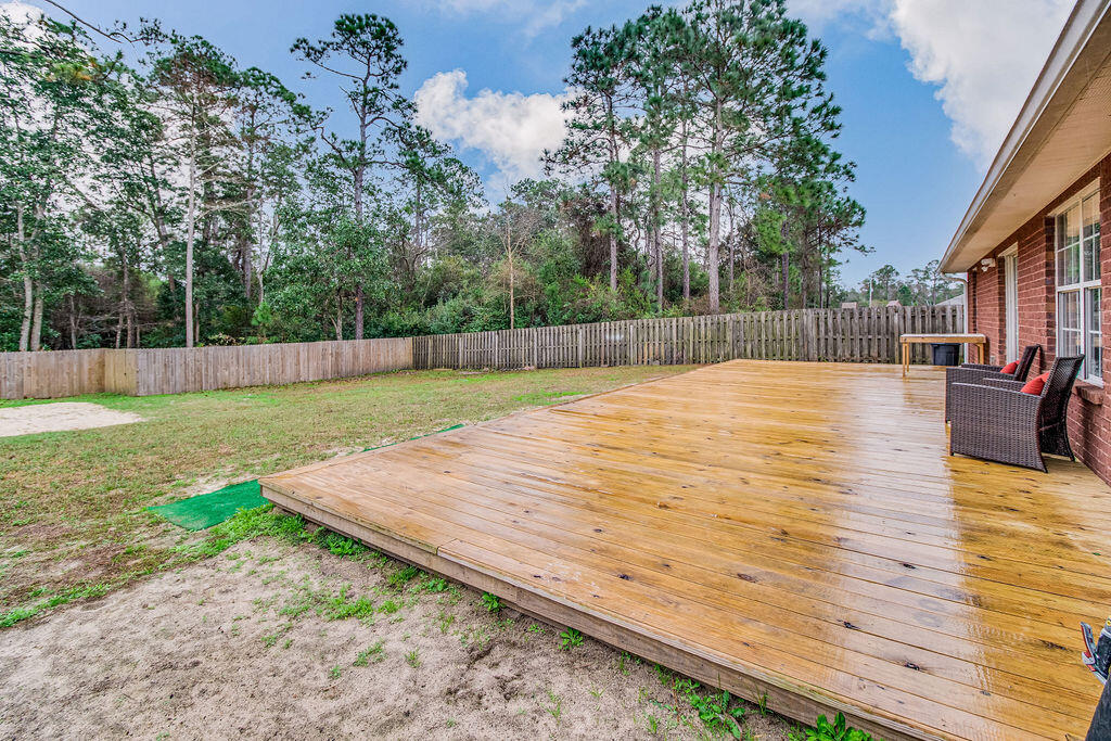 2442 Raider Lane Navarre, FL 32566 - Photo 46 of 46 a swimming pool with wooden fence