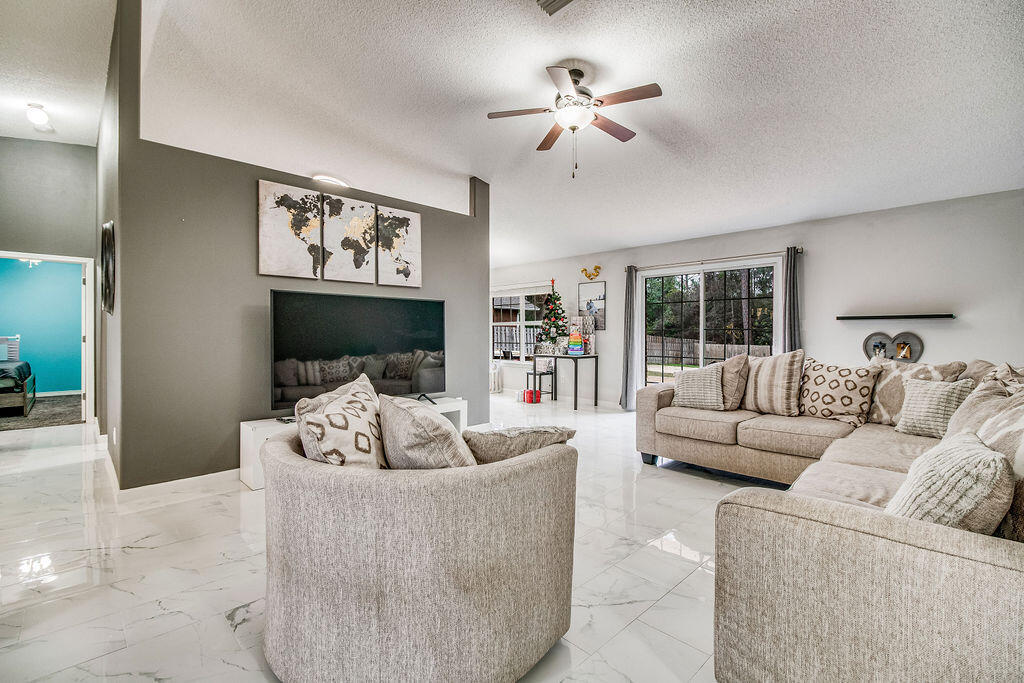 2442 Raider Lane Navarre, FL 32566 - Photo 7 of 46 a living room with furniture and a fireplace