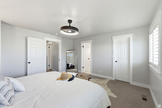 1405 Vintry Lane Murray, UT 84121 - Photo 17 of 44 Bedroom featuring neutral wall colors, contrasting white trim, a modern ceiling light fixture, and white plantation shutters