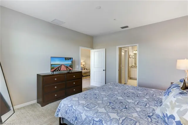 a bedroom with a bed and a mirror