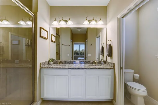 a bathroom with a granite countertop sink vanity and mirror