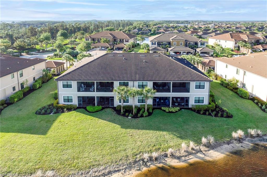 9433 Benvenuto Court, Unit 201 Naples, FL 34119 - Photo 24 of 32 a view of house with garden and patio
