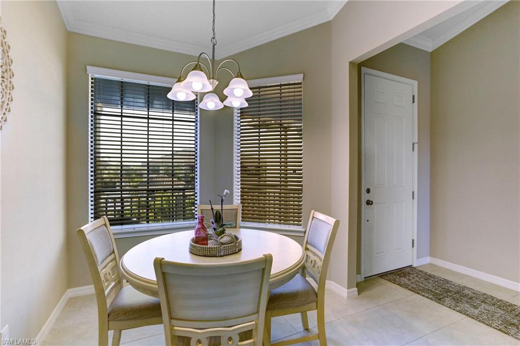 9433 Benvenuto Court, Unit 201 Naples, FL 34119 - Photo 7 of 32 a dining room with furniture and window