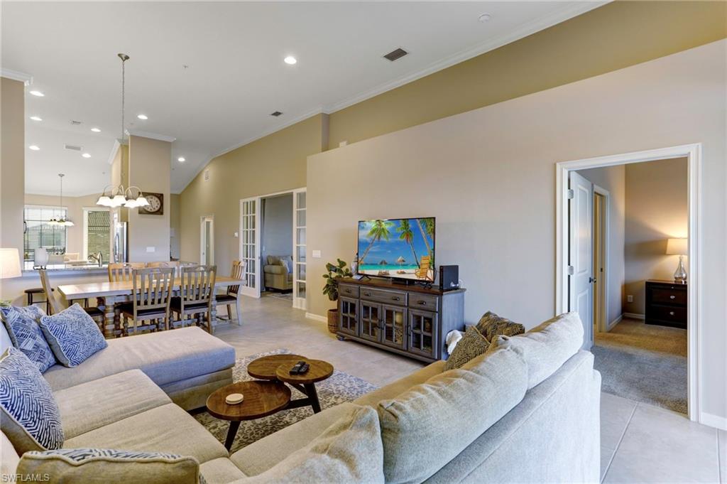 9433 Benvenuto Court, Unit 201 Naples, FL 34119 - Photo 8 of 32 a living room with furniture kitchen view and a wooden floor