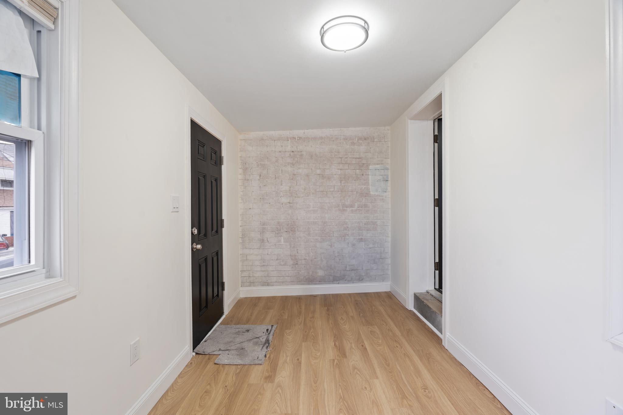 1118 Brown Street Chester, PA 19013 - Photo 11 of 27 an empty room with wooden floor and windows