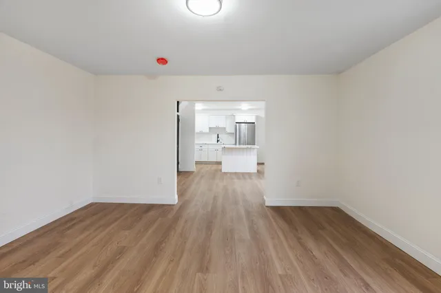 a view of a room with wooden floor and window