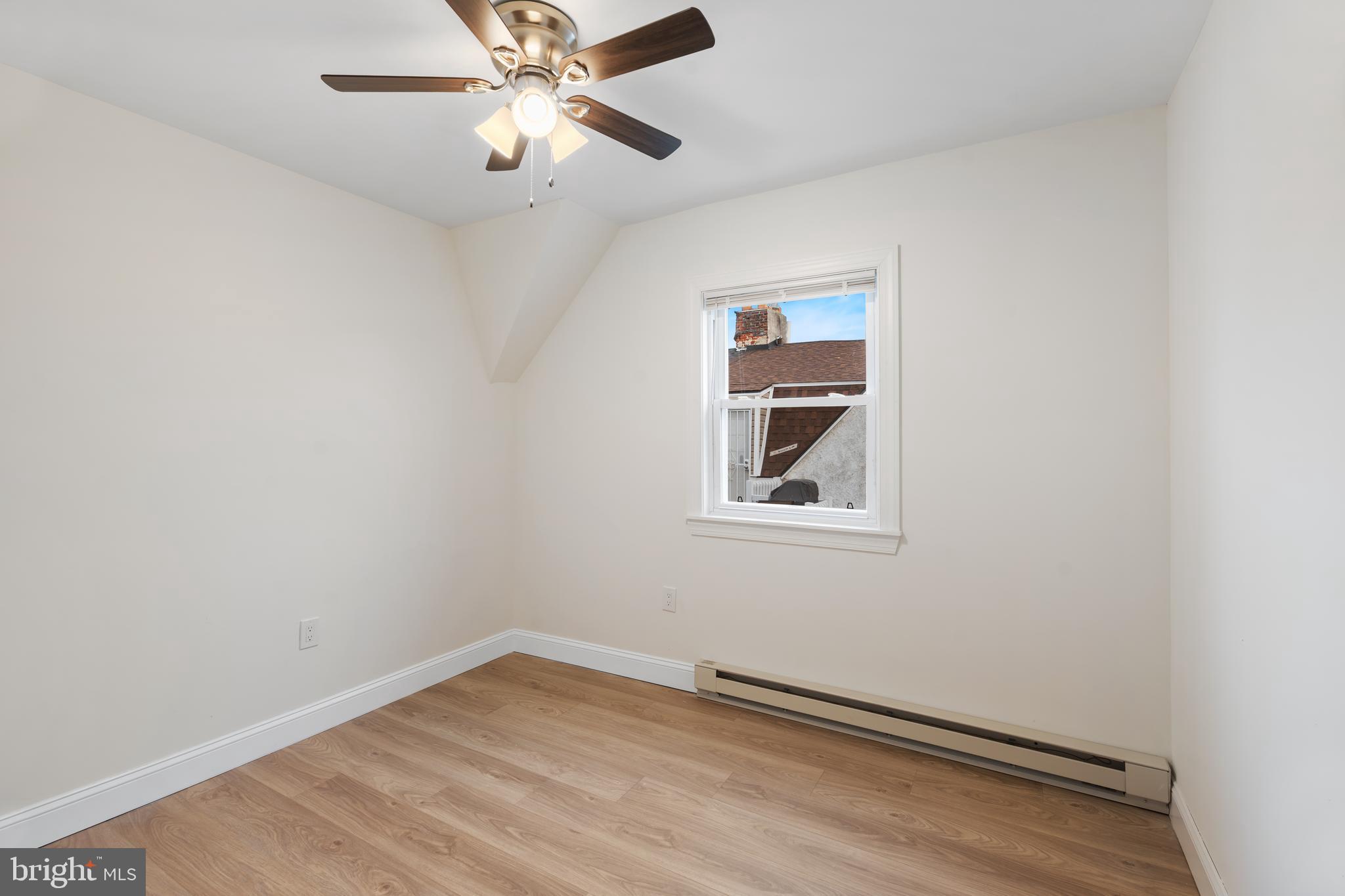 1118 Brown Street Chester, PA 19013 - Photo 18 of 27 an empty room with a window and a fan
