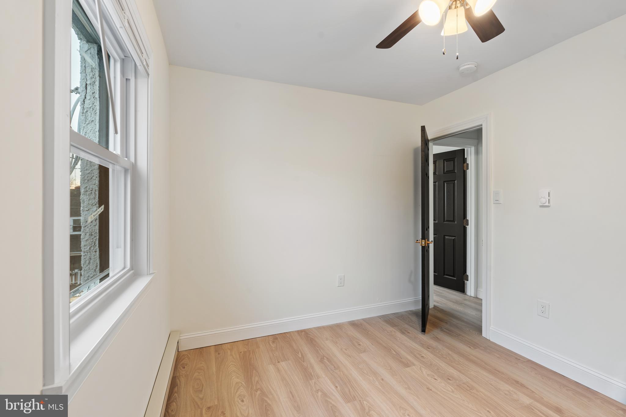 1118 Brown Street Chester, PA 19013 - Photo 21 of 27 wooden floor in an empty room with a window