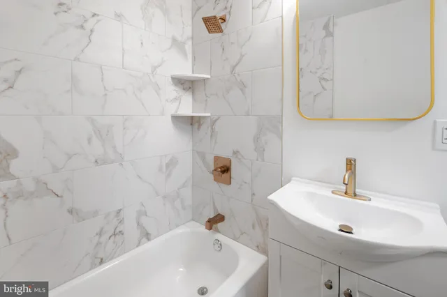 a bathroom with a sink a mirror and shower