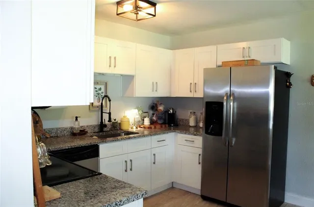 a kitchen with a refrigerator and a sink