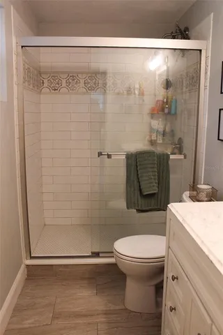 a bathroom with a toilet and a shower