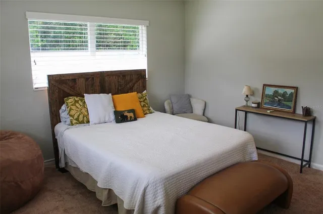 a bedroom with a bed and window