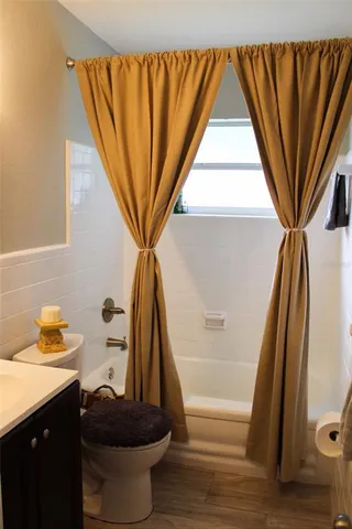 a bathroom with a sink a toilet and a shower