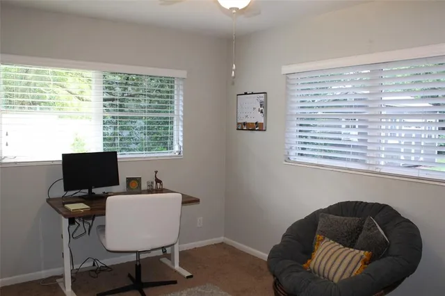 a work room with furniture and a window