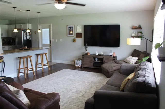 a living room with furniture and a flat screen tv