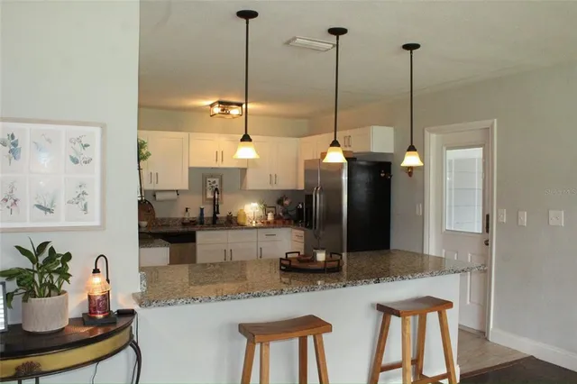 a kitchen with sink and refrigerator