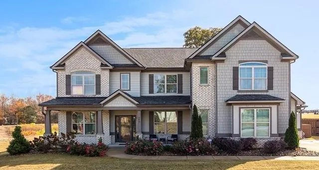 a front view of a house with a yard