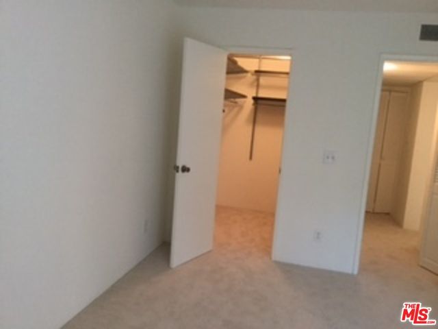 an empty room with mirror and entrance