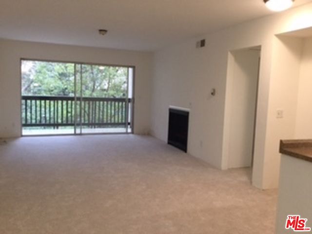 a view of an empty room with a balcony