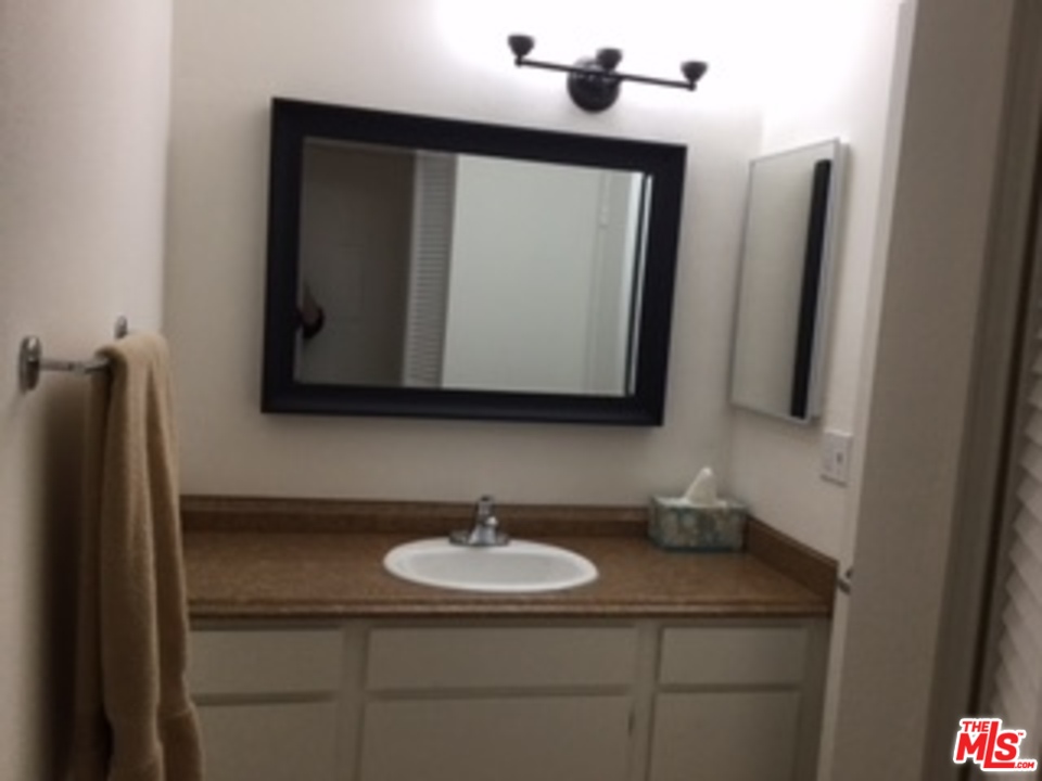 3110 Raintree Circle Culver City, CA 90230 - Photo 8 of 14 a bathroom with a sink and a mirror