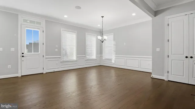 a kitchen with a sink a counter top space stainless steel appliances and cabinets