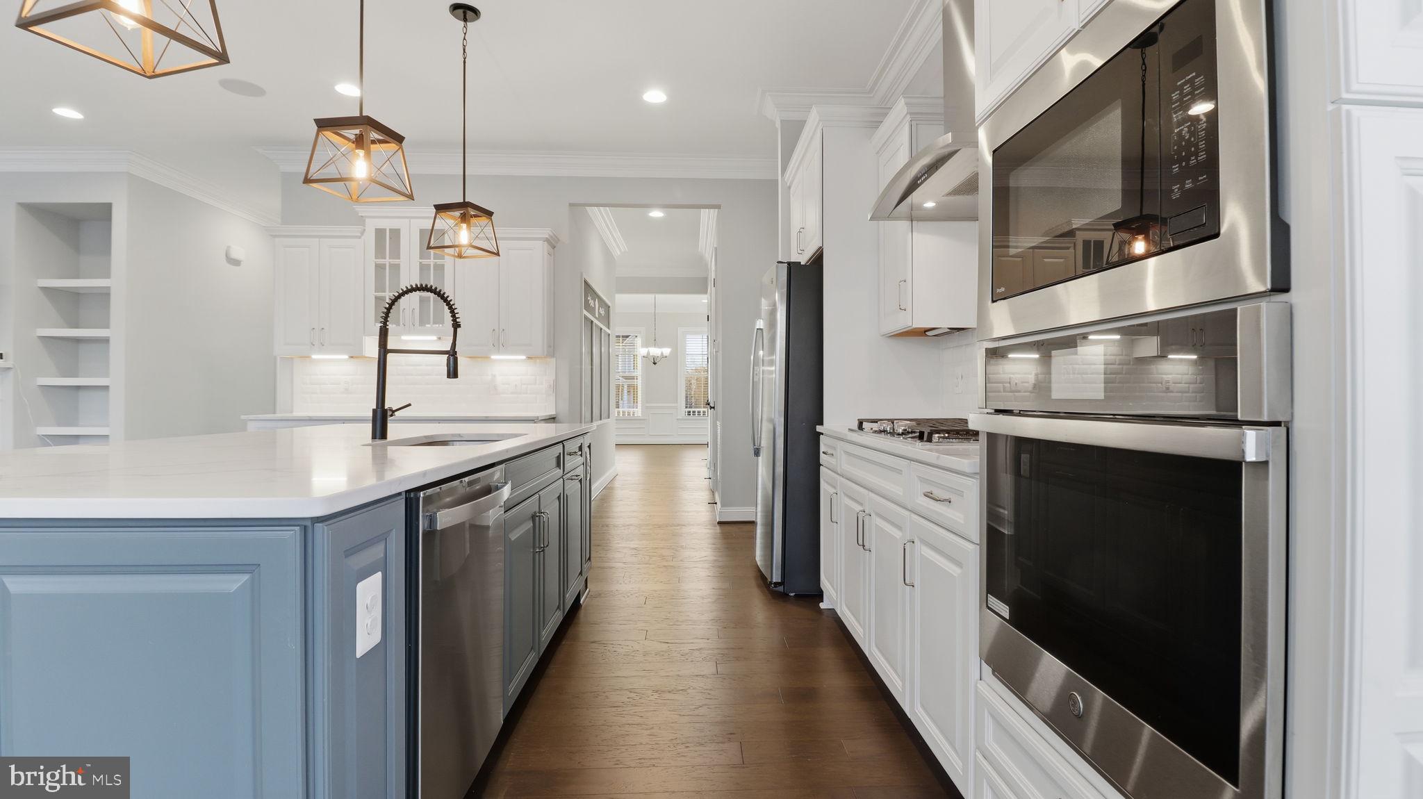 25956 Cullen Run Place Aldie, VA 20105 - Photo 37 of 109 a kitchen with white cabinets and stainless steel appliances