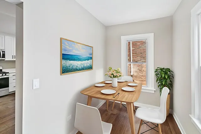 a view of a dining room with furniture window and wooden floor