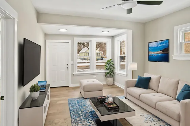 a living room with furniture a rug and a flat screen tv