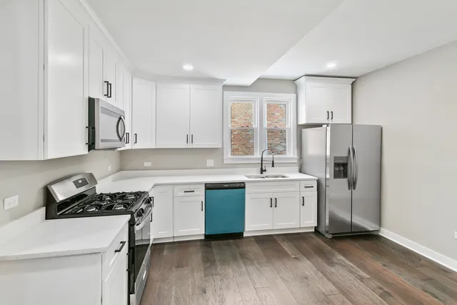 a kitchen with a sink stove and refrigerator