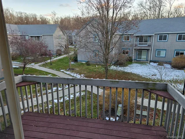 a view of a wooden deck and a yard