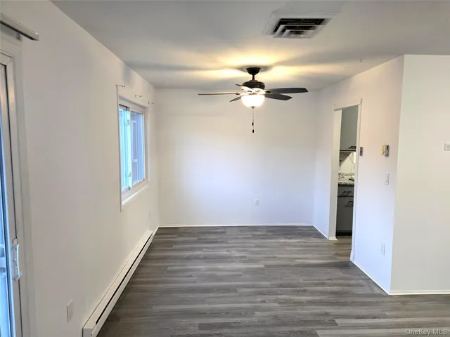 wooden floor in an empty room with a window