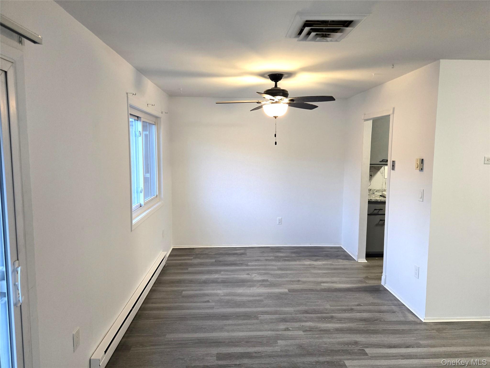 110 Sterling Street, Unit 110 Beacon, NY 12508 - Photo 4 of 14 wooden floor in an empty room with a window