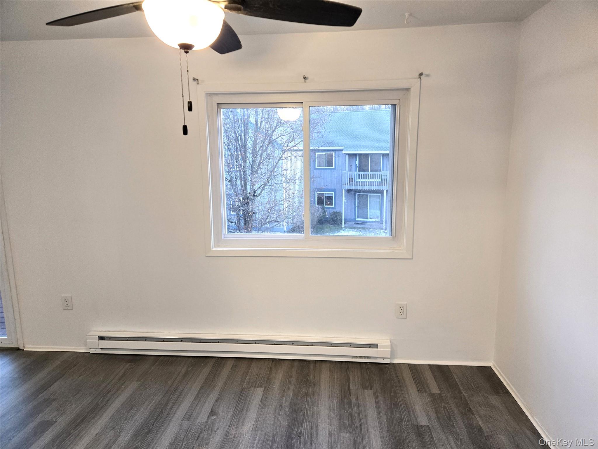 110 Sterling Street, Unit 110 Beacon, NY 12508 - Photo 5 of 14 a view of an empty room with wooden floor and a window