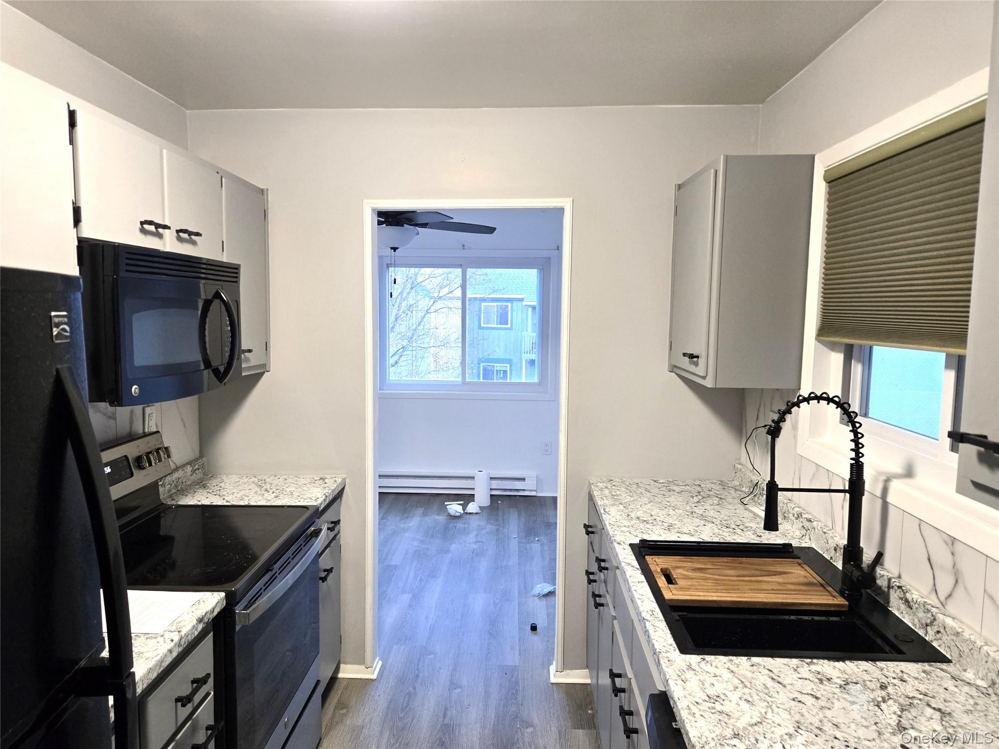 110 Sterling Street, Unit 110 Beacon, NY 12508 - Photo 6 of 14 a kitchen with wooden cabinets and a stove
