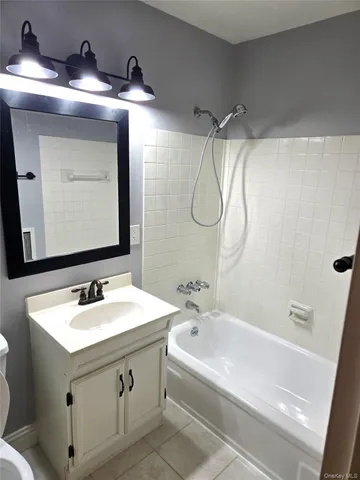 a bathroom with a sink vanity and a mirror