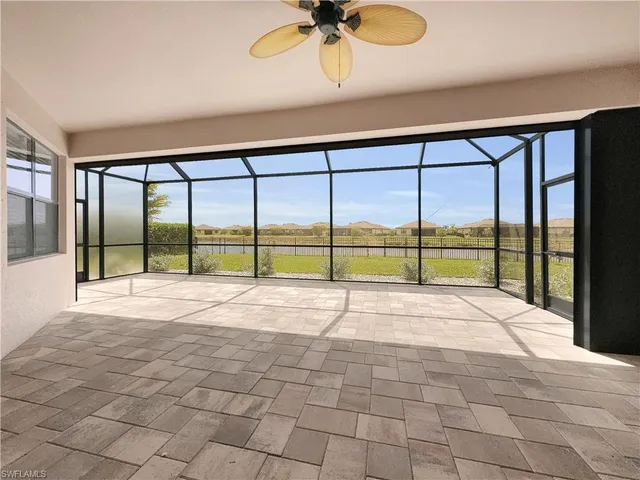 a view of an empty room with a floor to ceiling window and a ceiling fan
