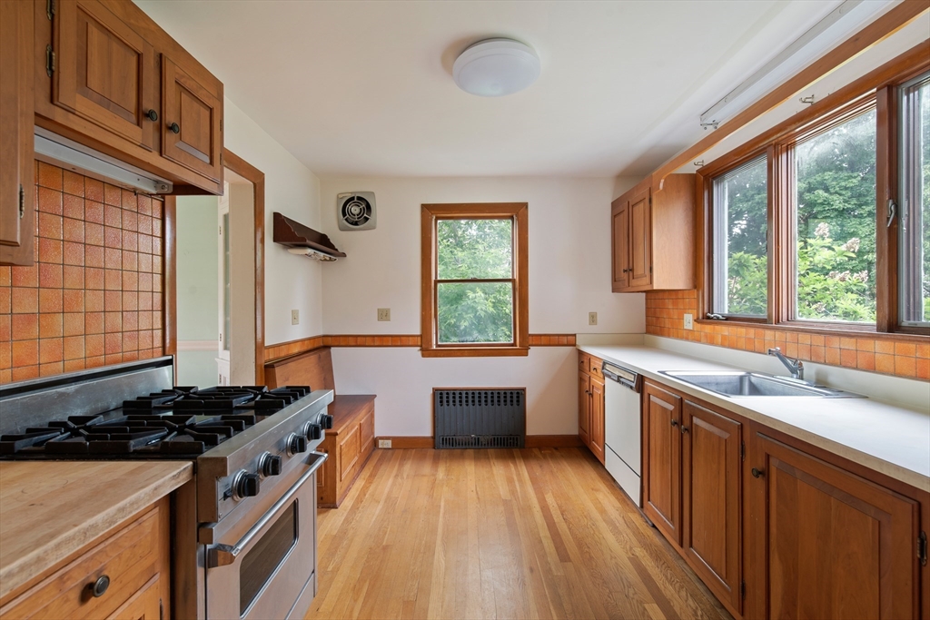 38 Bailey Road Arlington, MA 02476 - Photo 9 of 30 a kitchen with a sink stove top oven and wooden floor